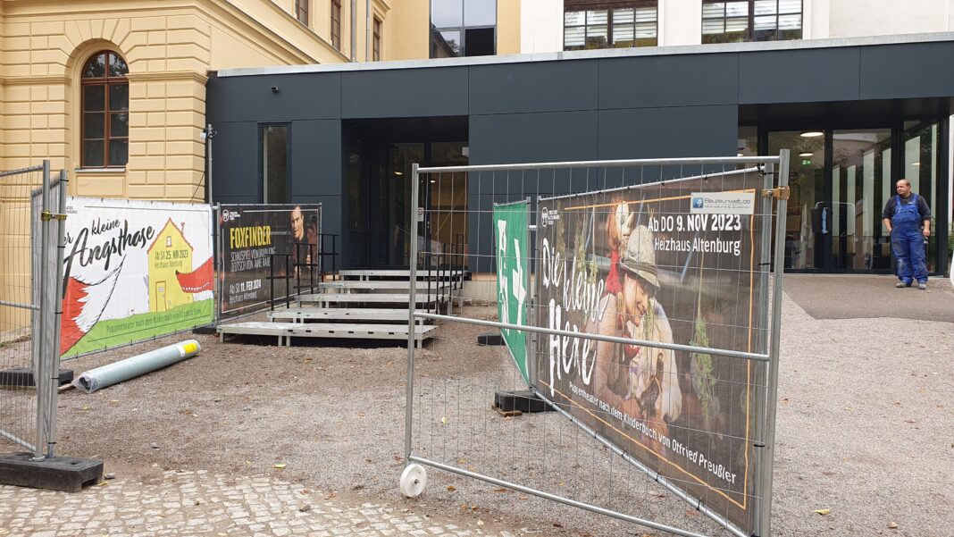 Vorm Heizhaus am Altenburger Landestheater ist noch Baustelle: Durch Absperrgitter und über eine Treppe werden die Zuschauer ins Gebäude geführt.