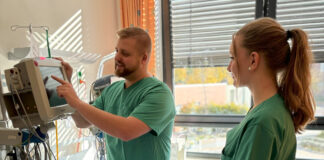 Hauptpraxisanleiter Philipp Teich zeigt einer Auszubildenden, wie man die Vitalzeichen misst. Foto: SKH Altscherbitz