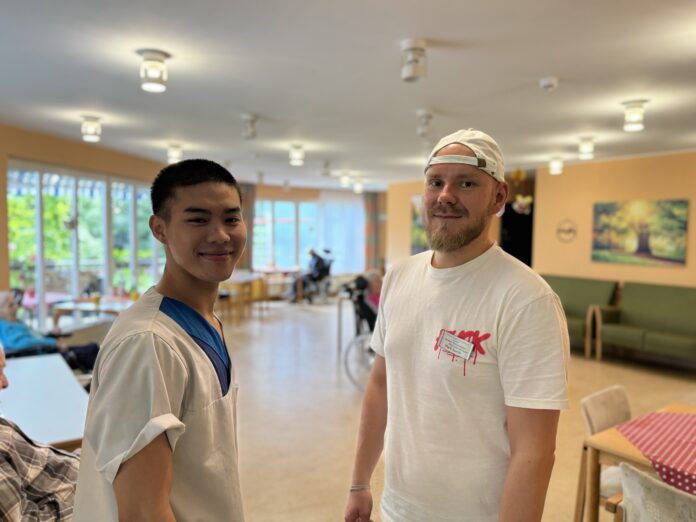 Mark Specht (re.) begleitet die Azubis bei der Diakonie, wie Phong Van Nguyen, w&auml;hrend ihrer praktischen Eins&auml;tze im Pflegeheim.