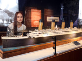Frau schaut sich Modell der Titanic an