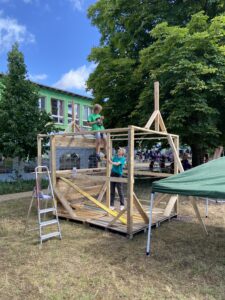 Oskar verschraubt unter den Augen der Betreuerin die Bretter des Verkaufsstandes der Kreativ-Kids &ndash; aus Paletten entsteht Schritt f&uuml;r Schritt ein stabiler Verkaufsplatz f&uuml;r die selbstgemachten Produkte. Foto: Nannette Hoffmann 